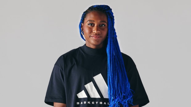 Aliyah Boston poses in a black Adidas shirt.